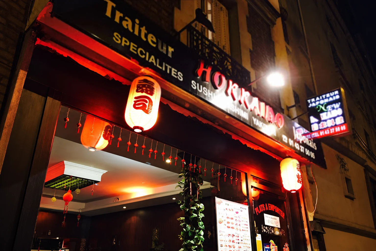 The restaurant front with the Hokkaido sign and red lanterns, in the evening.